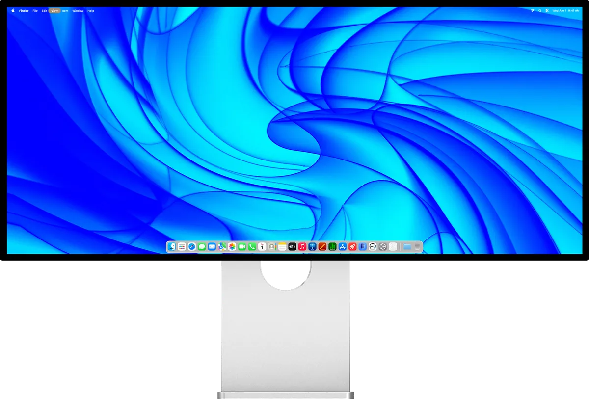 Écran ultra-large Kuycon W34KB vu de face sur son pied en aluminium, affichant le bureau de macOS sur un fond d'écran bleu